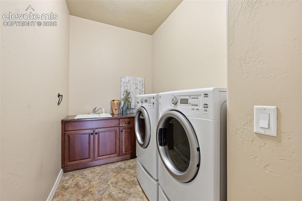 13184 Cake Bread Heights Colorado Springs, CO 80921 - Photo 25 of 47 Large laundry with sink and storage