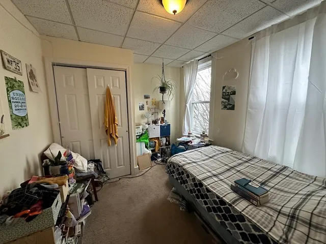 a bedroom with bed and a window