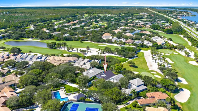an aerial view of residential houses with outdoor space and trees