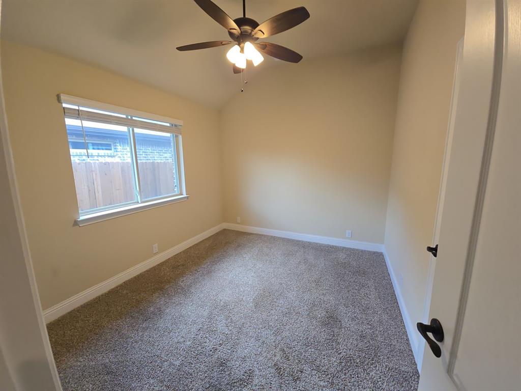 4031 Three Forks Road Kaufman, TX 75142 - Photo 11 of 26 an empty room with a window and a fan