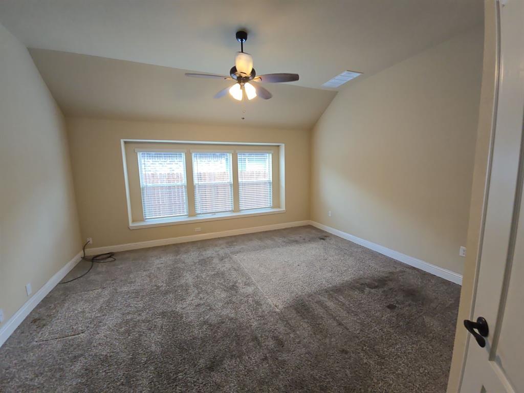 4031 Three Forks Road Kaufman, TX 75142 - Photo 13 of 26 en empty room with windows and chandelier