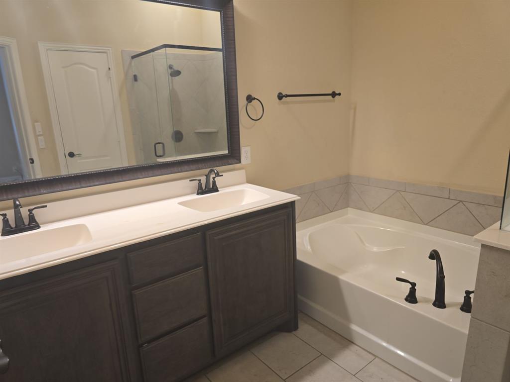 4031 Three Forks Road Kaufman, TX 75142 - Photo 18 of 26 a bathroom with a tub sink and mirror