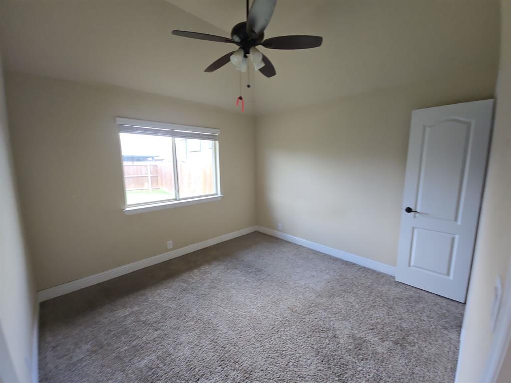 4031 Three Forks Road Kaufman, TX 75142 - Photo 7 of 26 an empty room with a window and a fan