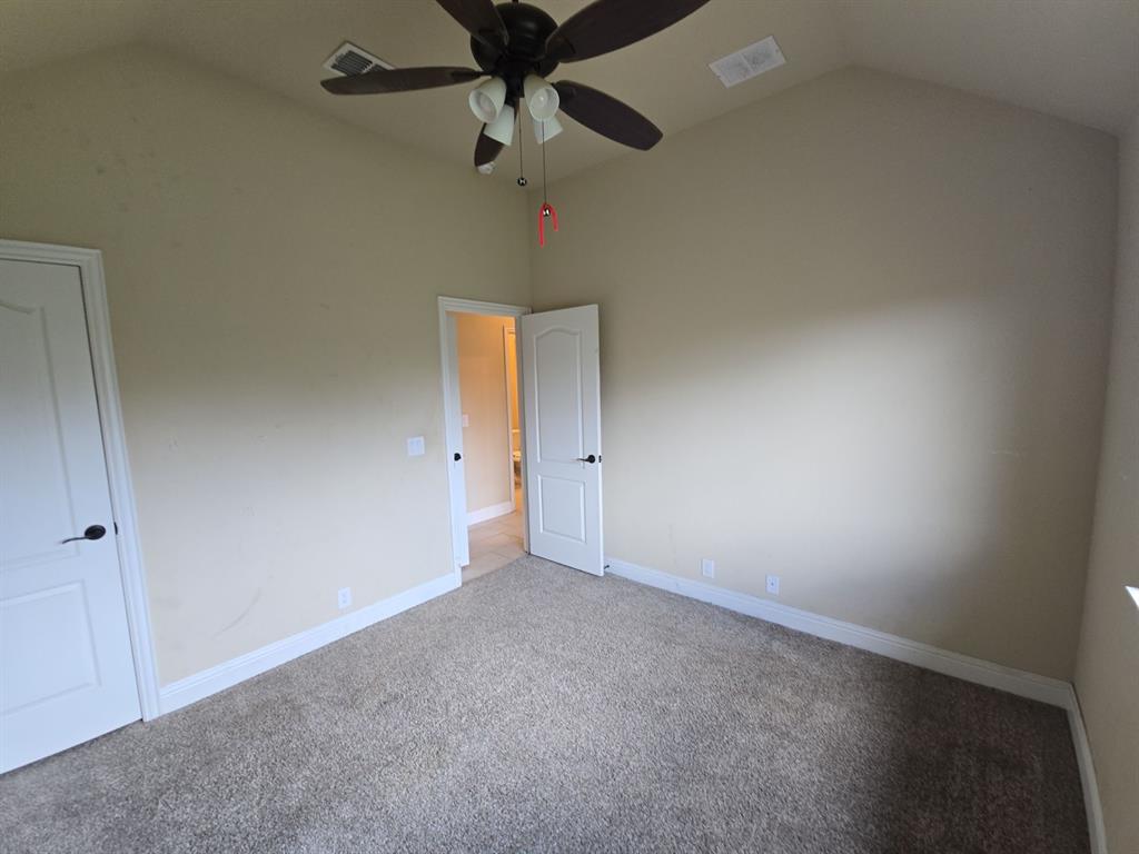 4031 Three Forks Road Kaufman, TX 75142 - Photo 9 of 26 en empty room with ceiling fan and window