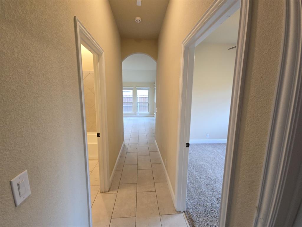 4031 Three Forks Road Kaufman, TX 75142 - Photo 10 of 26 a view of a hallway with wooden floor and a bathroom