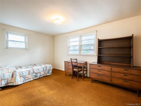 a bedroom with bed and window