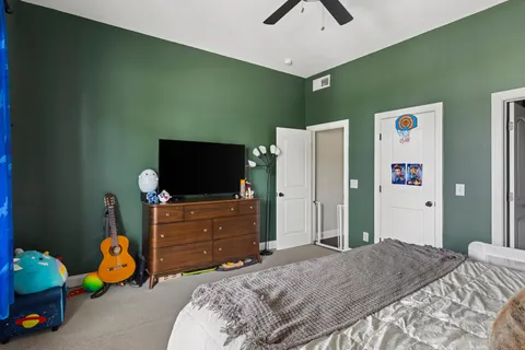 a bedroom with a bed and a tv