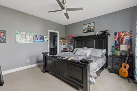 a bedroom with bed and a chandelier