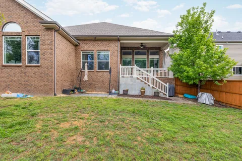 a view of a house with backyard porch and a garden