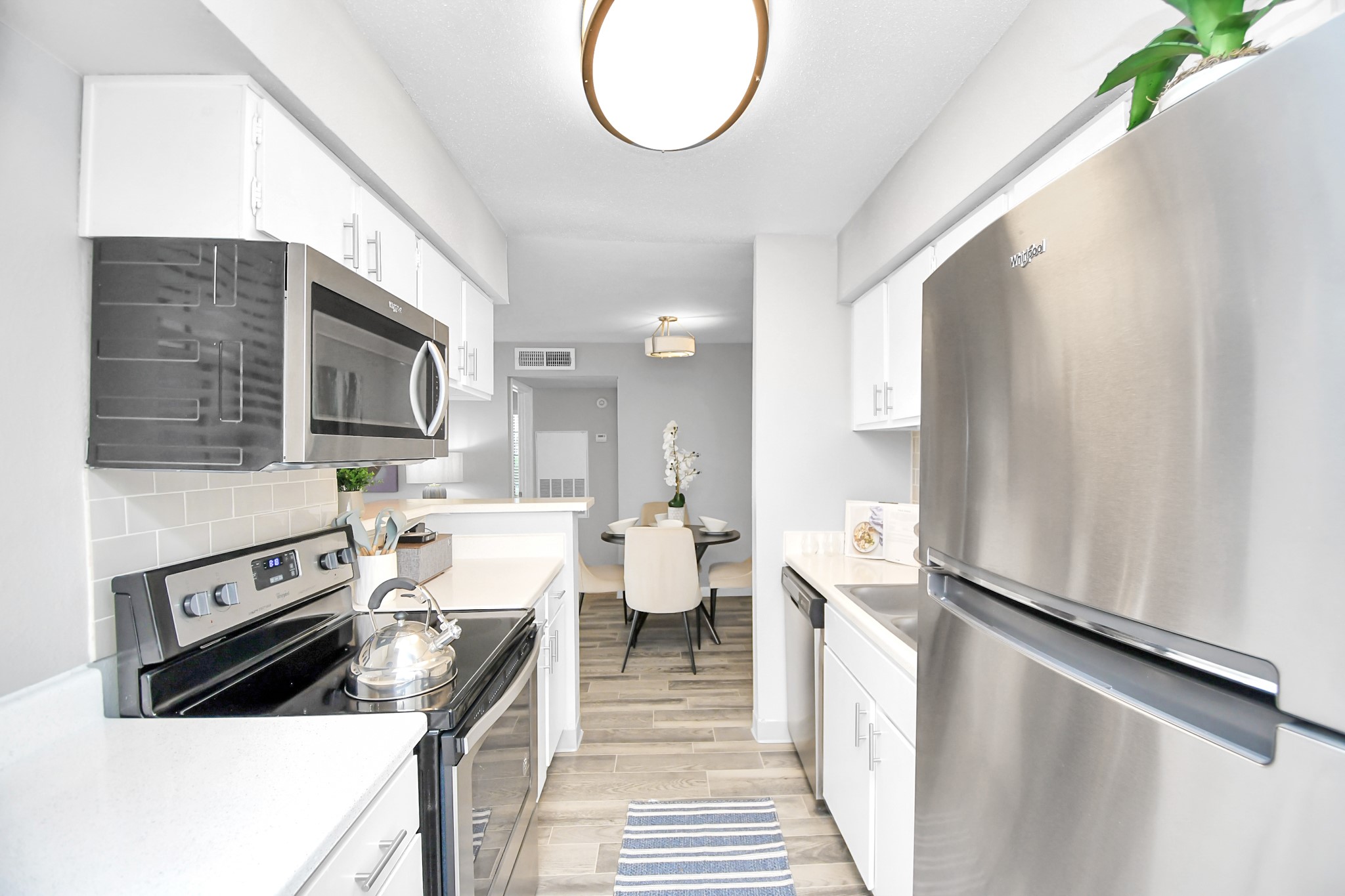 2701 West Bellfort Avenue, Unit 1016 Houston, TX 77054 - Photo 11 of 44 a kitchen with a white stove refrigerator and cabinets