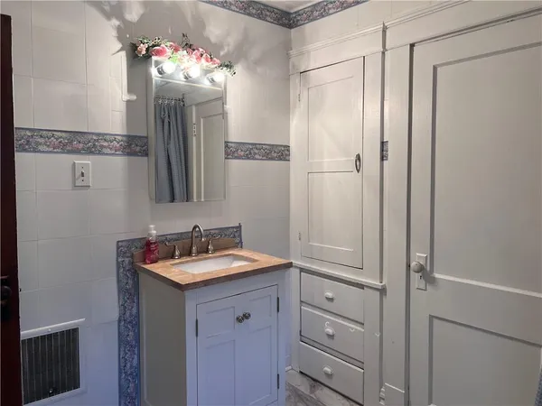 a bathroom with a sink and a mirror