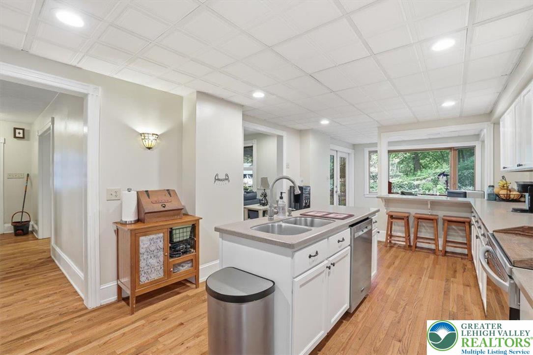3585 Fairyland Road Lehighton, PA 18235 - Photo 22 of 57 a kitchen with a sink stove and wooden cabinets