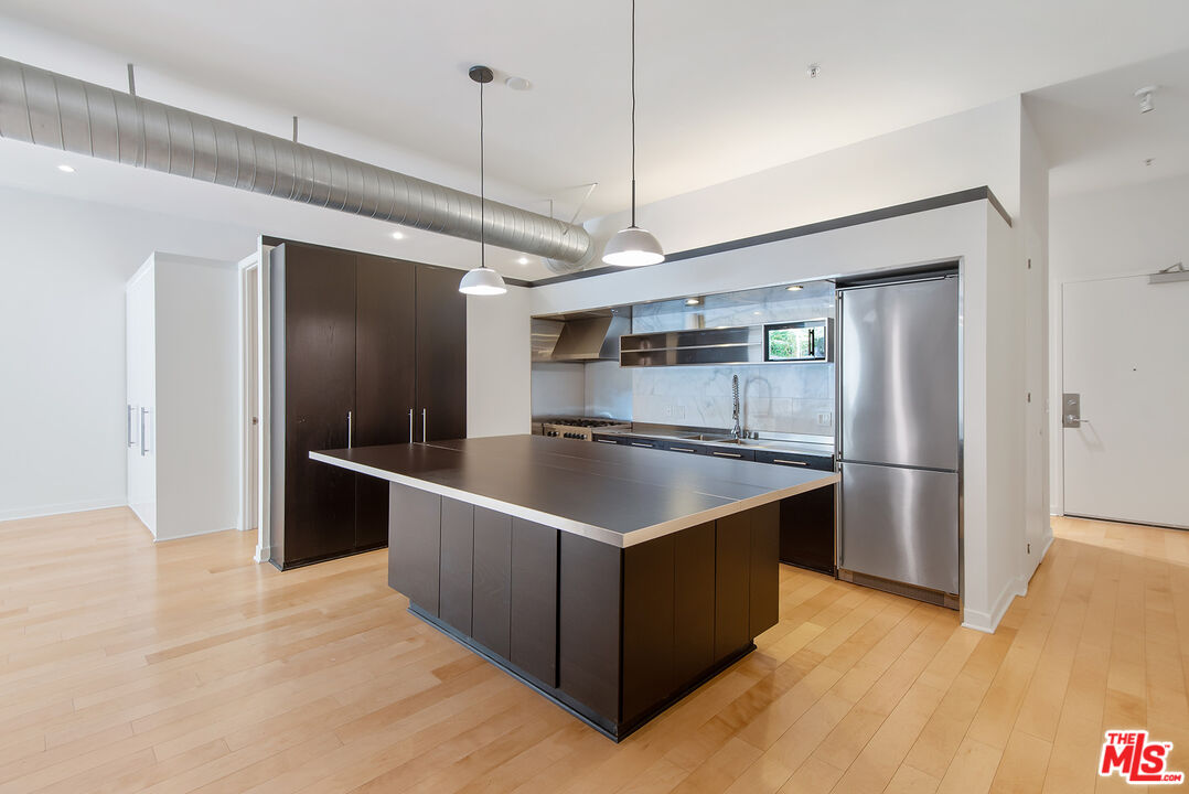 a kitchen with stainless steel appliances granite countertop a sink a counter space and stainless steel appliances