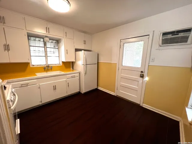 a kitchen with stainless steel appliances a refrigerator and a stove