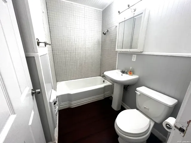 a white toilet sitting next to a bathroom sink