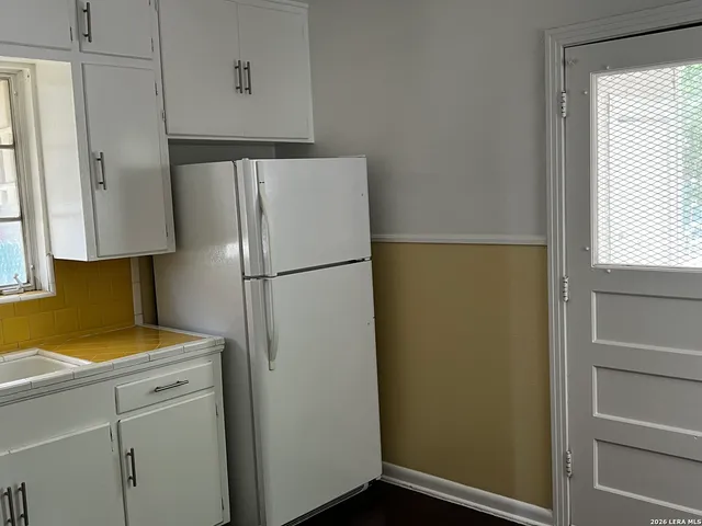 a white refrigerator freezer sitting inside of a kitchen