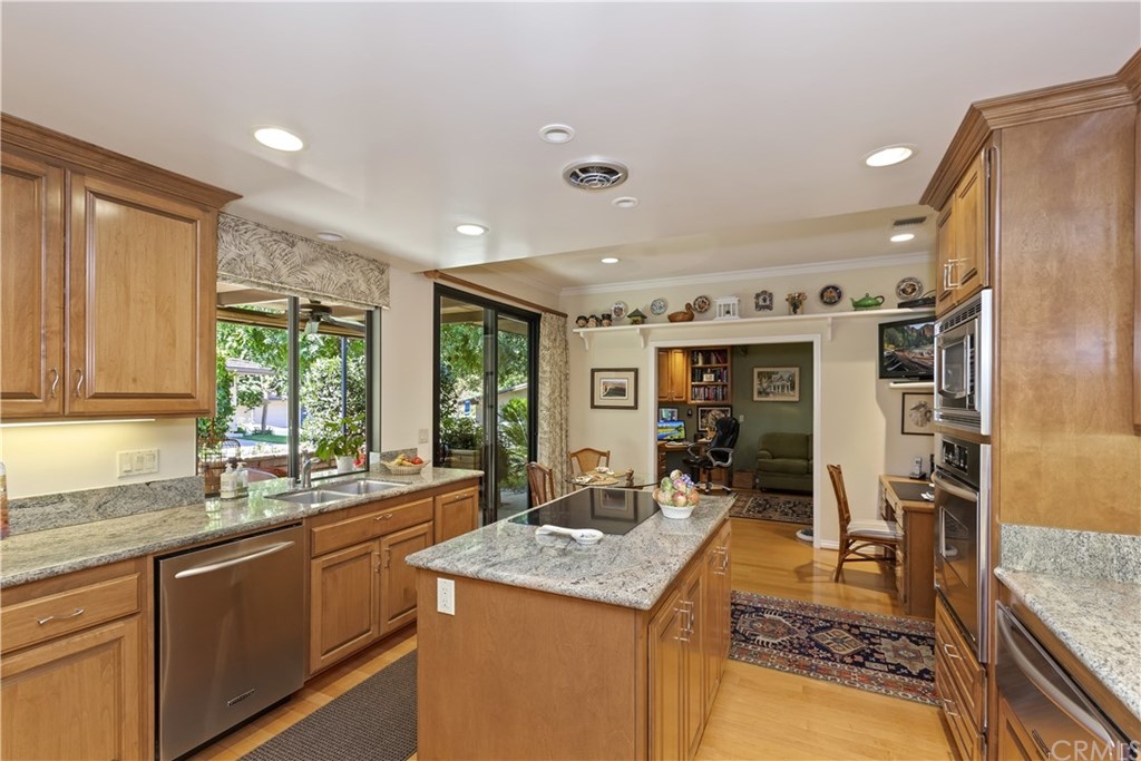 6272 Tecate Drive Riverside, CA 92506 - Photo 17 of 39 a kitchen with granite countertop a sink and a refrigerator