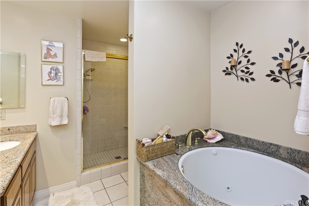 6272 Tecate Drive Riverside, CA 92506 - Photo 30 of 39 a bathroom with a tub sink and mirror