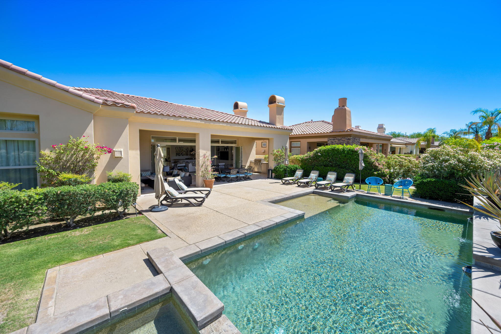 81785 Brown Deer Park La Quinta, CA 92253 - Photo 26 of 57 a view of a patio with table and chairs and potted plants
