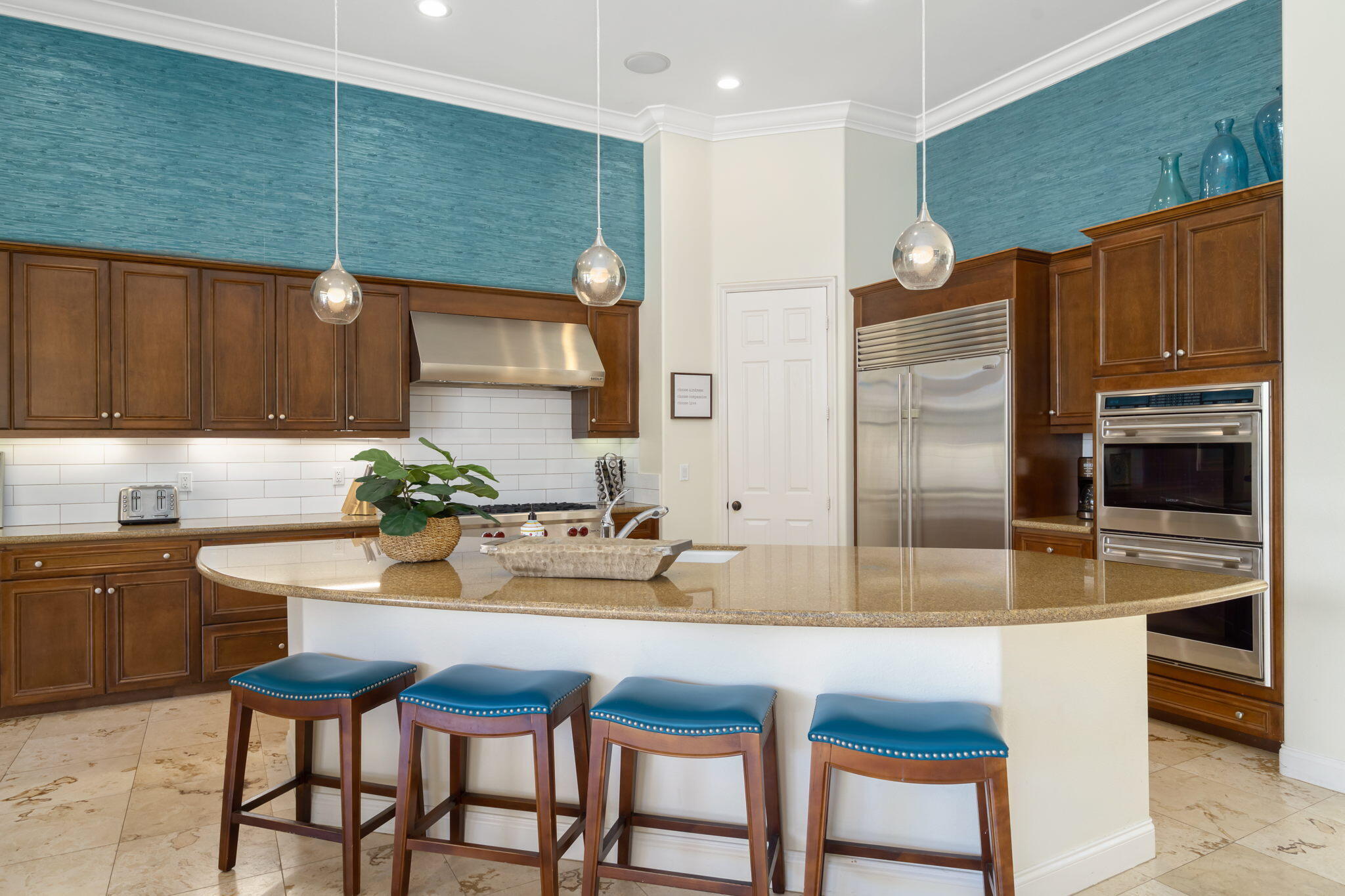 81785 Brown Deer Park La Quinta, CA 92253 - Photo 29 of 57 a kitchen with a table chairs refrigerator and cabinets