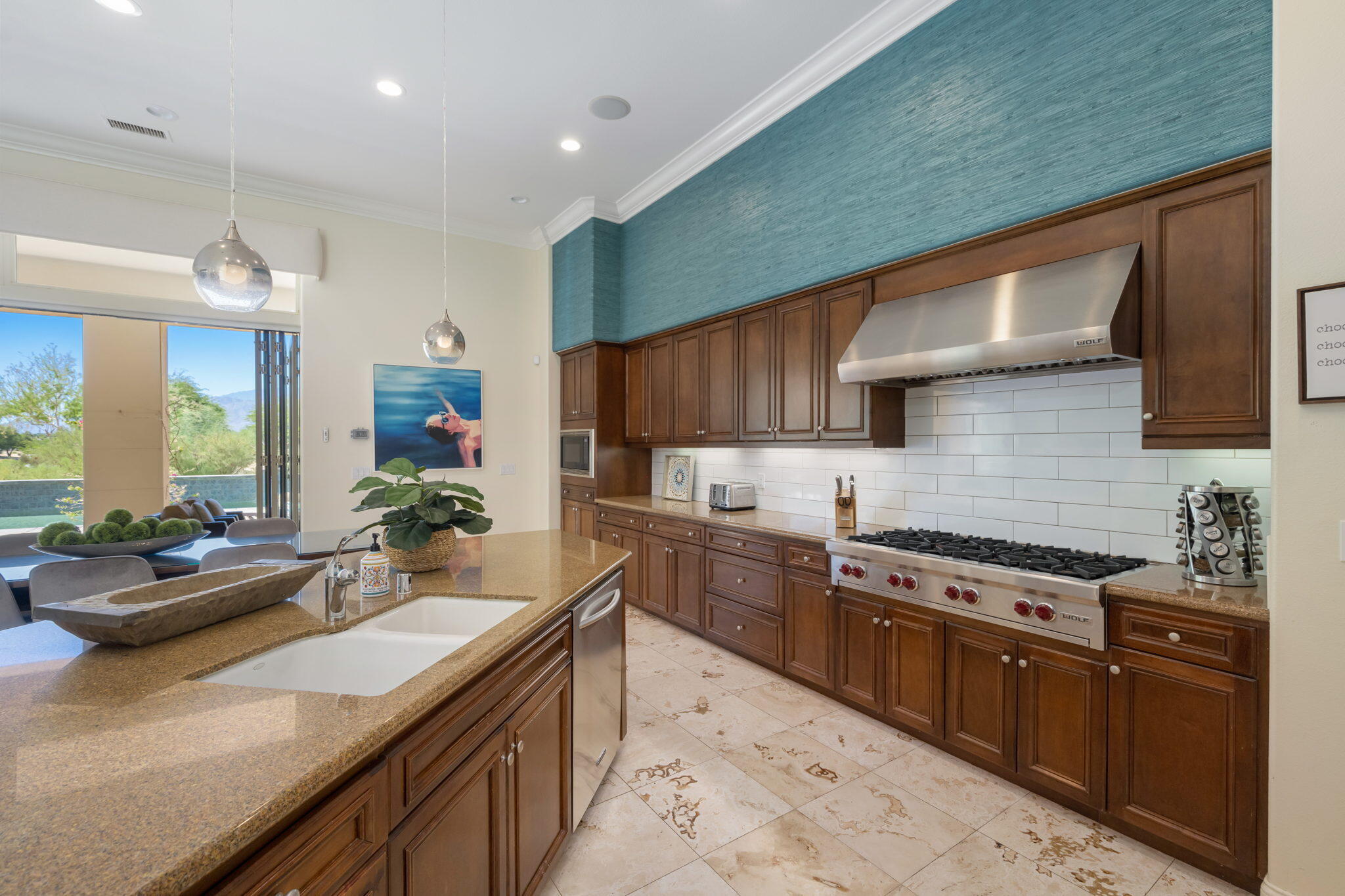81785 Brown Deer Park La Quinta, CA 92253 - Photo 31 of 57 a kitchen with stainless steel appliances granite countertop sink stove and cabinets