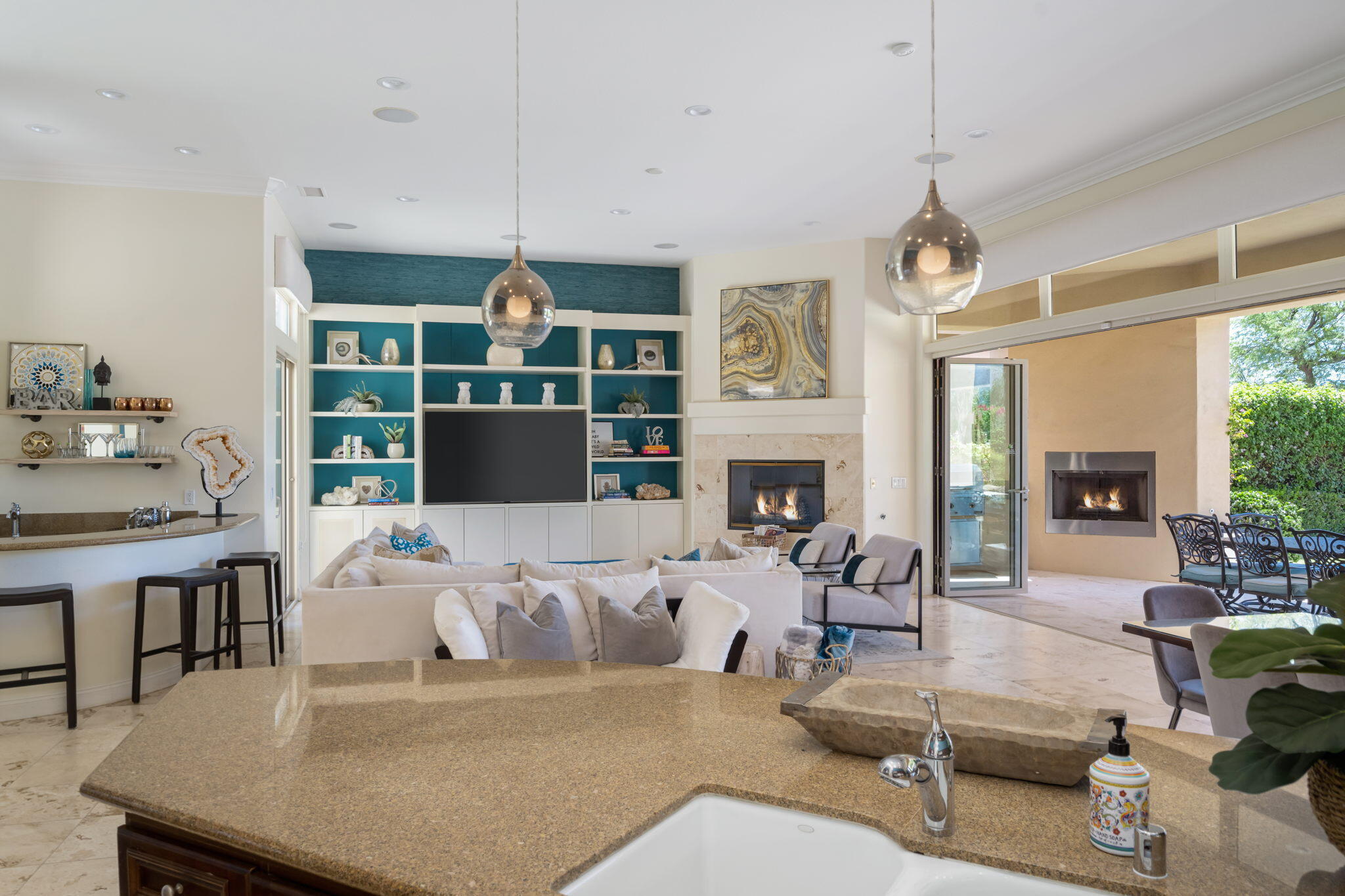 81785 Brown Deer Park La Quinta, CA 92253 - Photo 33 of 57 a living room with furniture a fireplace and a chandelier