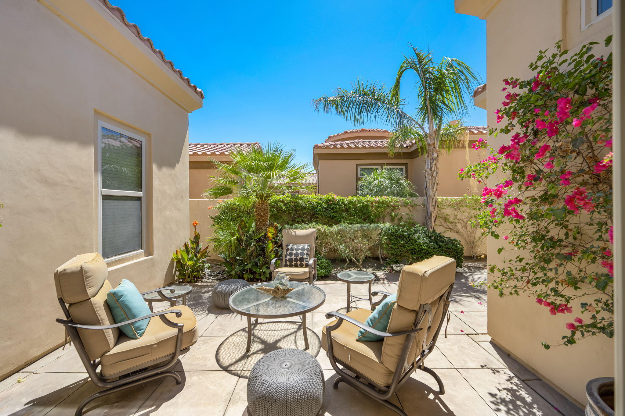 81785 Brown Deer Park La Quinta, CA 92253 - Photo 36 of 57 a view of a patio with table and chairs and potted plants
