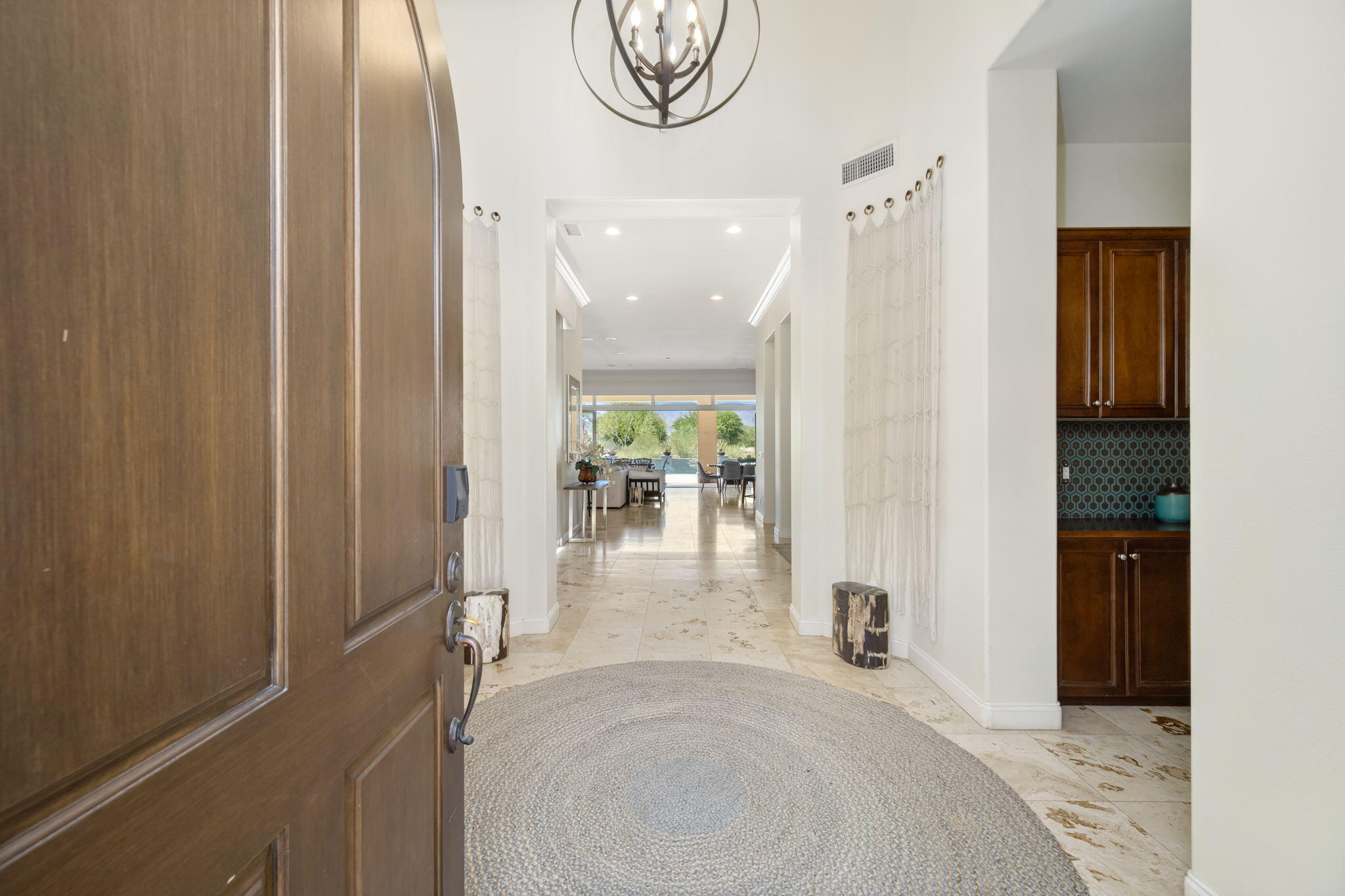 81785 Brown Deer Park La Quinta, CA 92253 - Photo 9 of 57 a view of a hallway with furniture and a chandelier