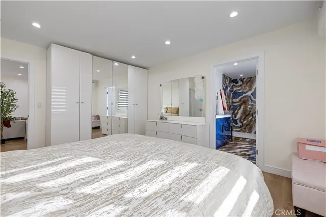 a kitchen with stainless steel appliances granite countertop a dining table chairs refrigerator sink and cabinets