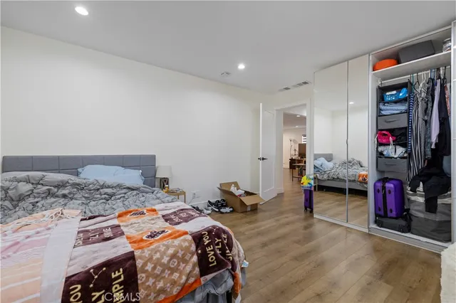 a kitchen with kitchen island stainless steel appliances a sink a stove top oven and cabinets