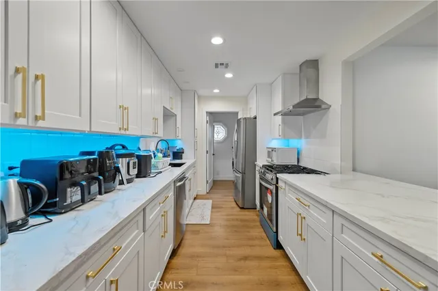 a kitchen with a sink a stove and cabinets