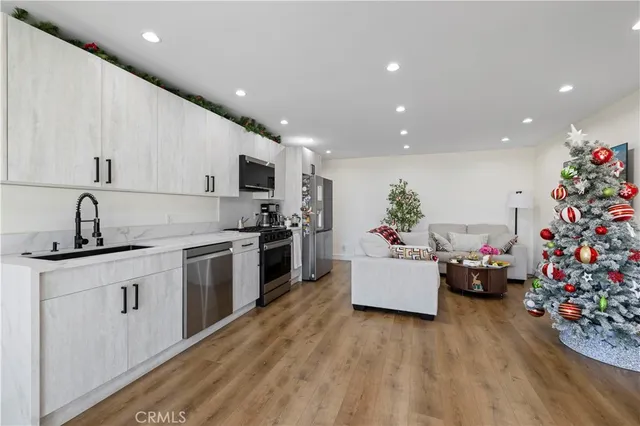 a kitchen with a sink stainless steel appliances and cabinets