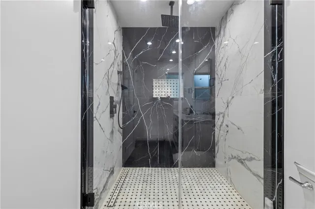 a bathroom with a granite countertop toilet sink and mirror