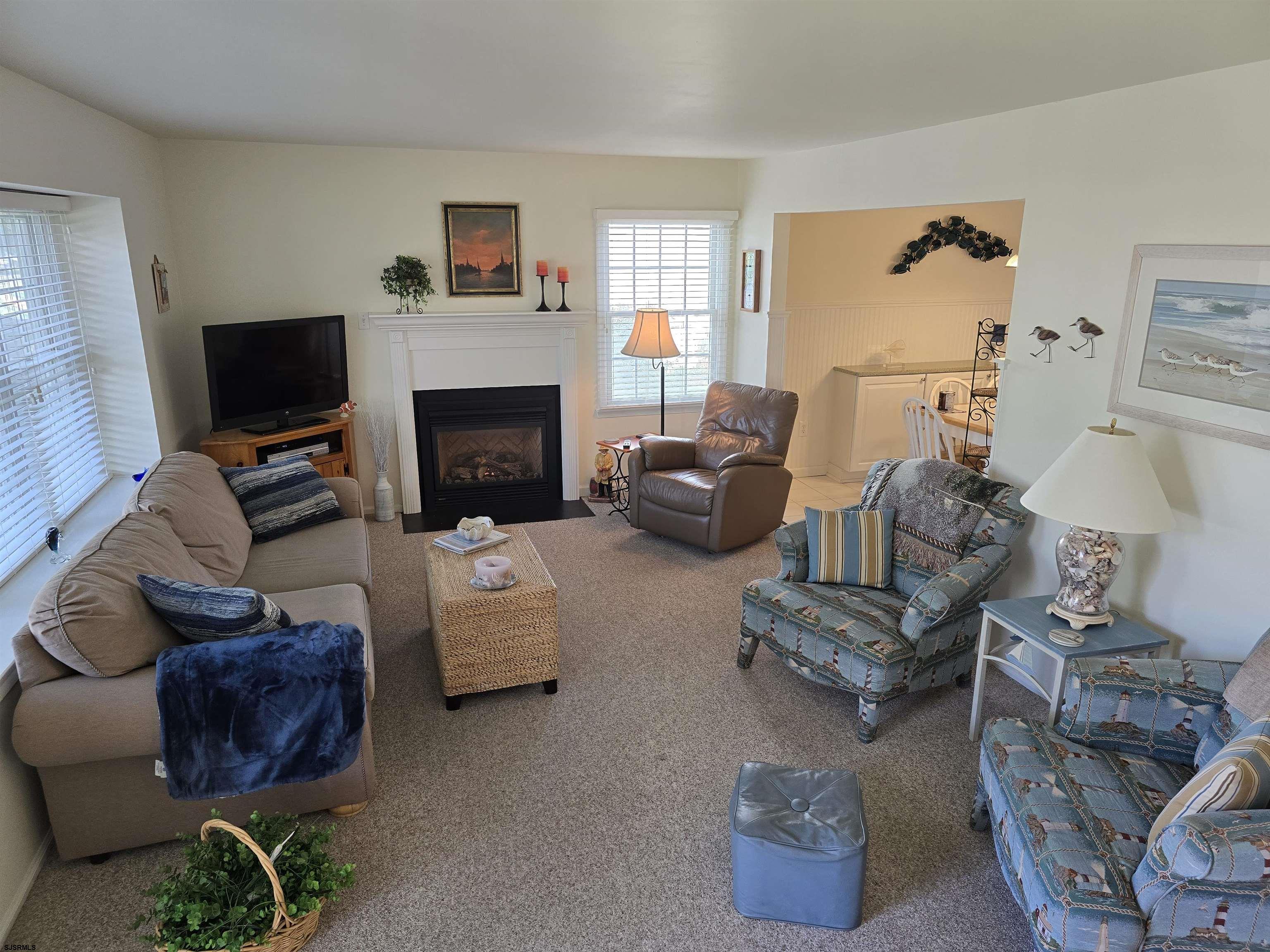 9 Gull Cove Brigantine, NJ 08203 - Photo 14 of 20 a living room with furniture and a fireplace