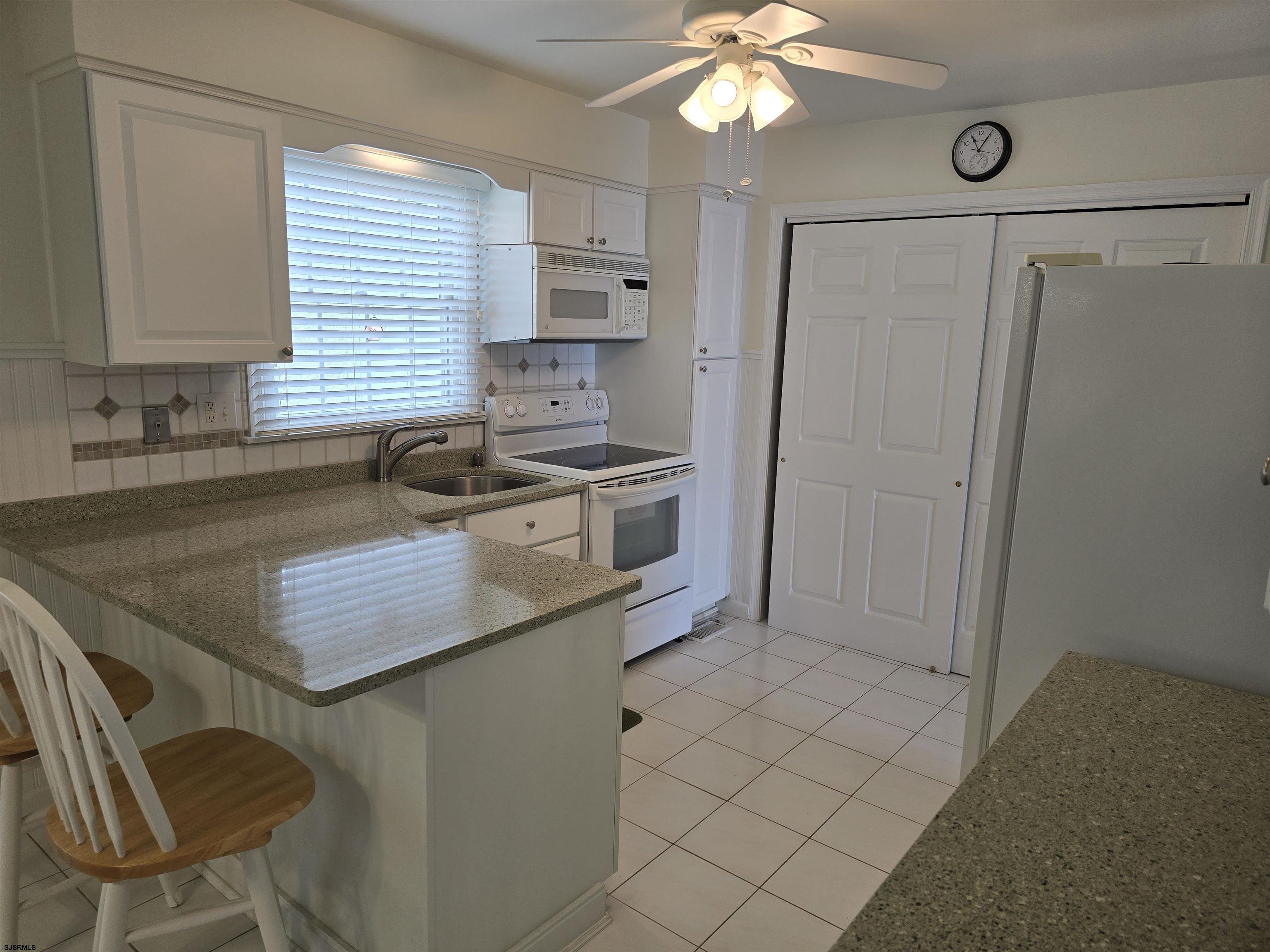 9 Gull Cove Brigantine, NJ 08203 - Photo 15 of 20 a kitchen with stainless steel appliances granite countertop a sink stove and refrigerator