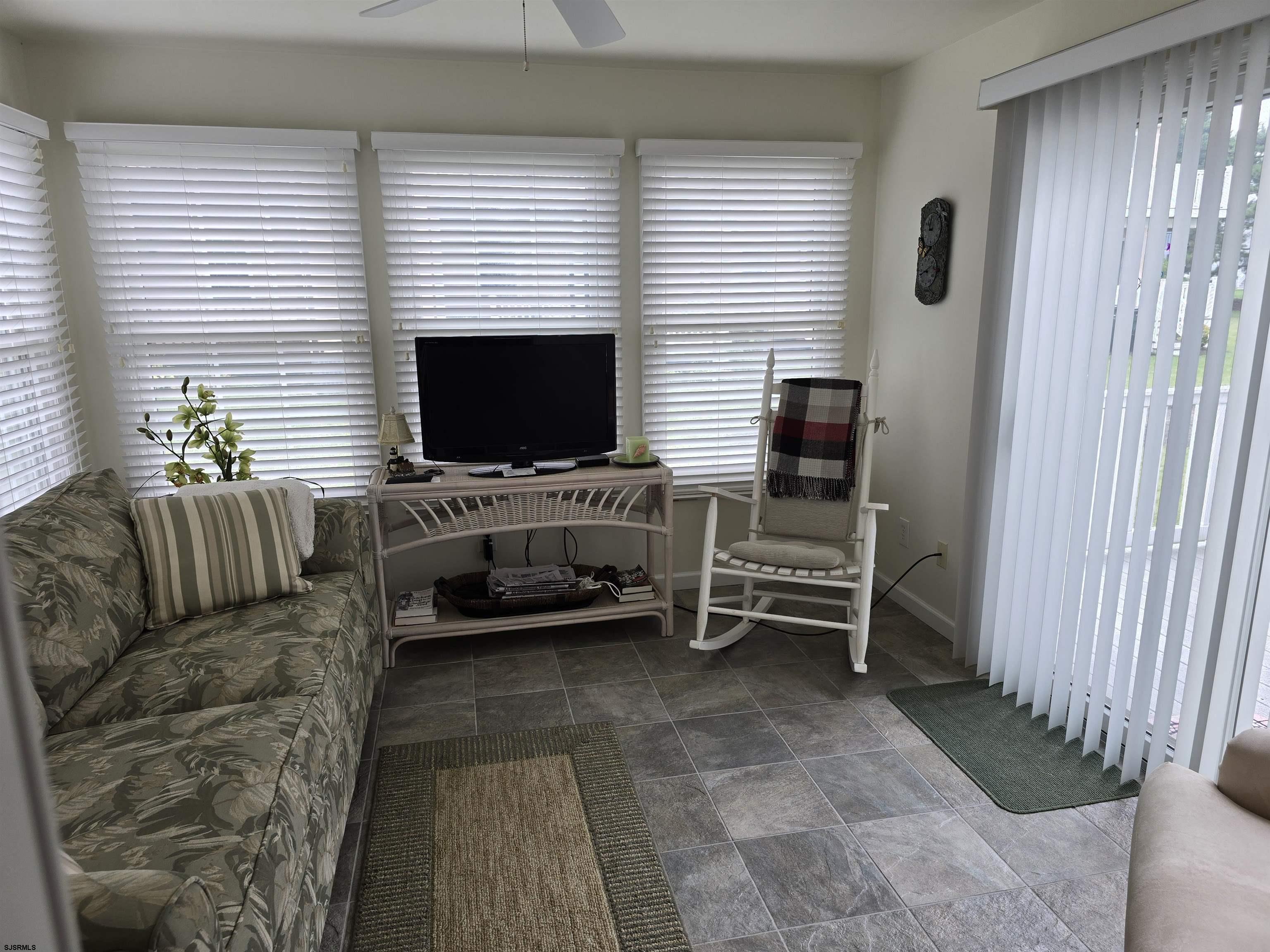 9 Gull Cove Brigantine, NJ 08203 - Photo 17 of 20 a living room with furniture and a flat screen tv