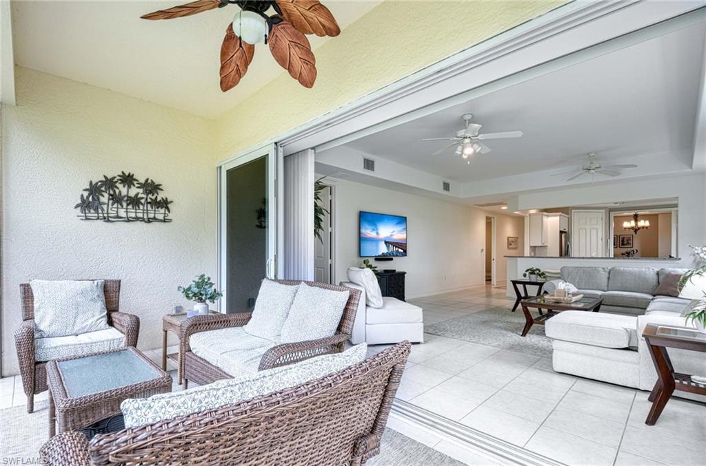 8649 Champions Point, Unit 1201 Naples, FL 34113 - Photo 11 of 23 Great entertainment space with 12' pocket sliders from lanai to living area