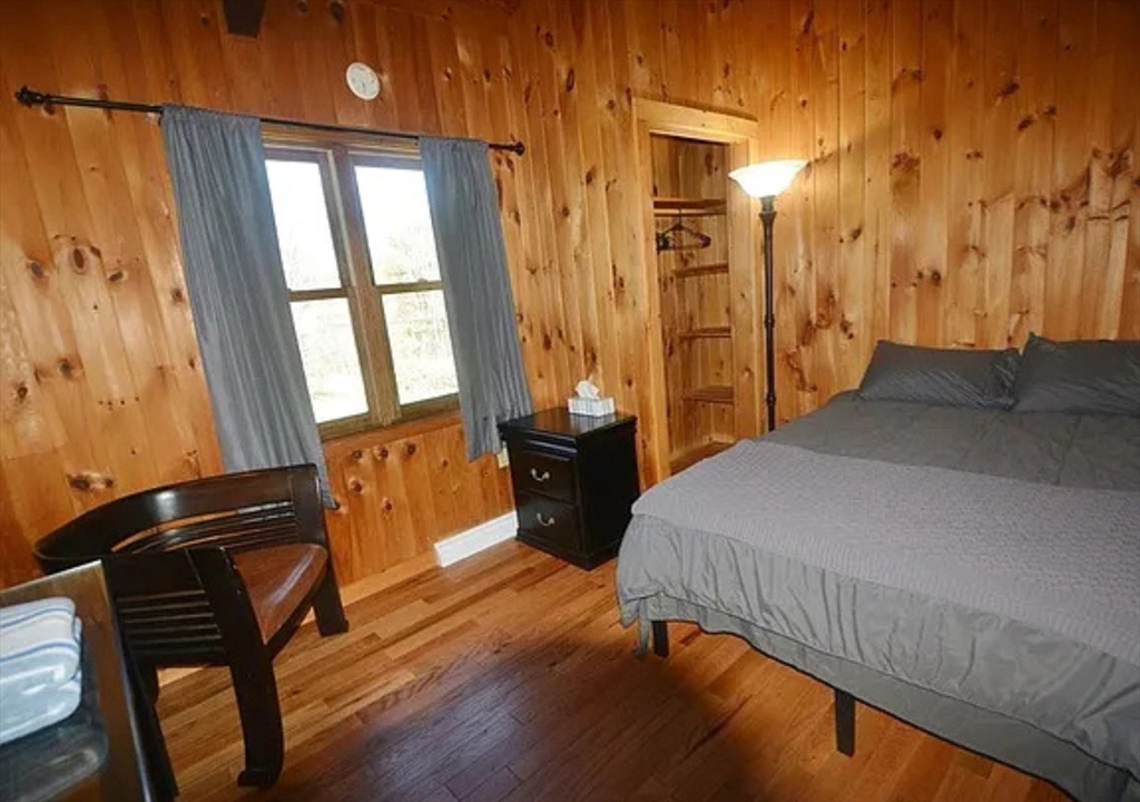1828 East Otis Road Otis, MA 01029 - Photo 13 of 25 a bedroom with a bed and wooden floor
