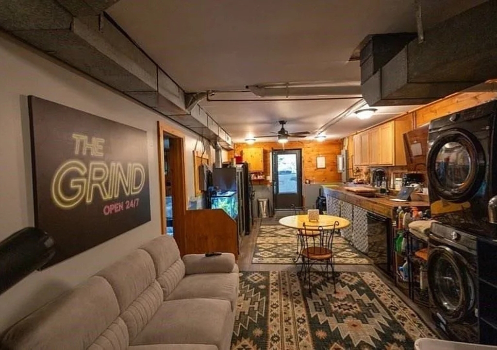 1828 East Otis Road Otis, MA 01029 - Photo 16 of 25 a living room with furniture a fireplace and a chandelier