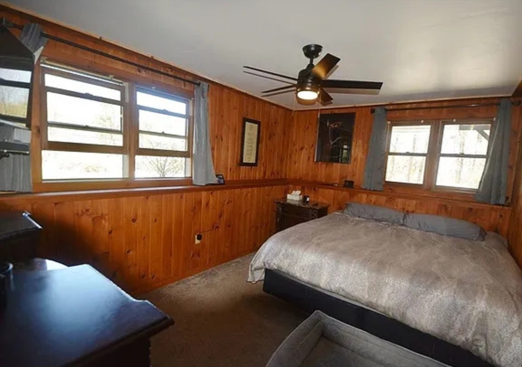 1828 East Otis Road Otis, MA 01029 - Photo 17 of 24 a bedroom with a bed and a chandelier