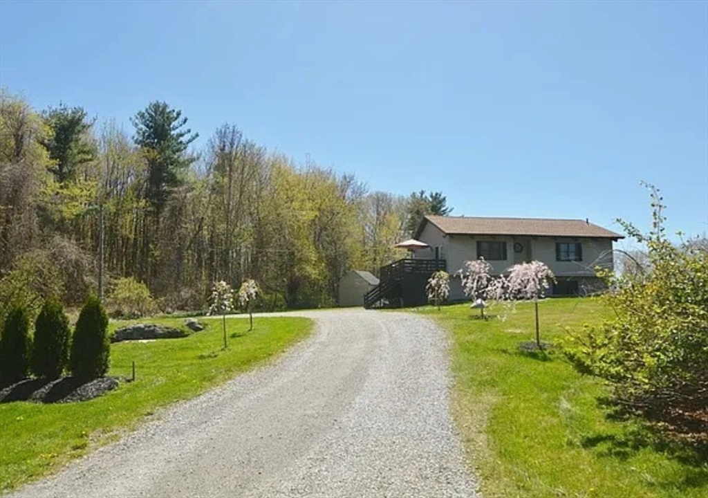 1828 East Otis Road Otis, MA 01029 - Photo 7 of 24 a front view of a house with a yard and trees