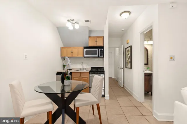 a kitchen with stainless steel appliances kitchen island granite countertop a refrigerator and a stove top oven