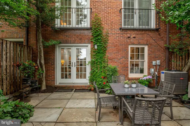 a view of house with backyard outdoor seating and plants