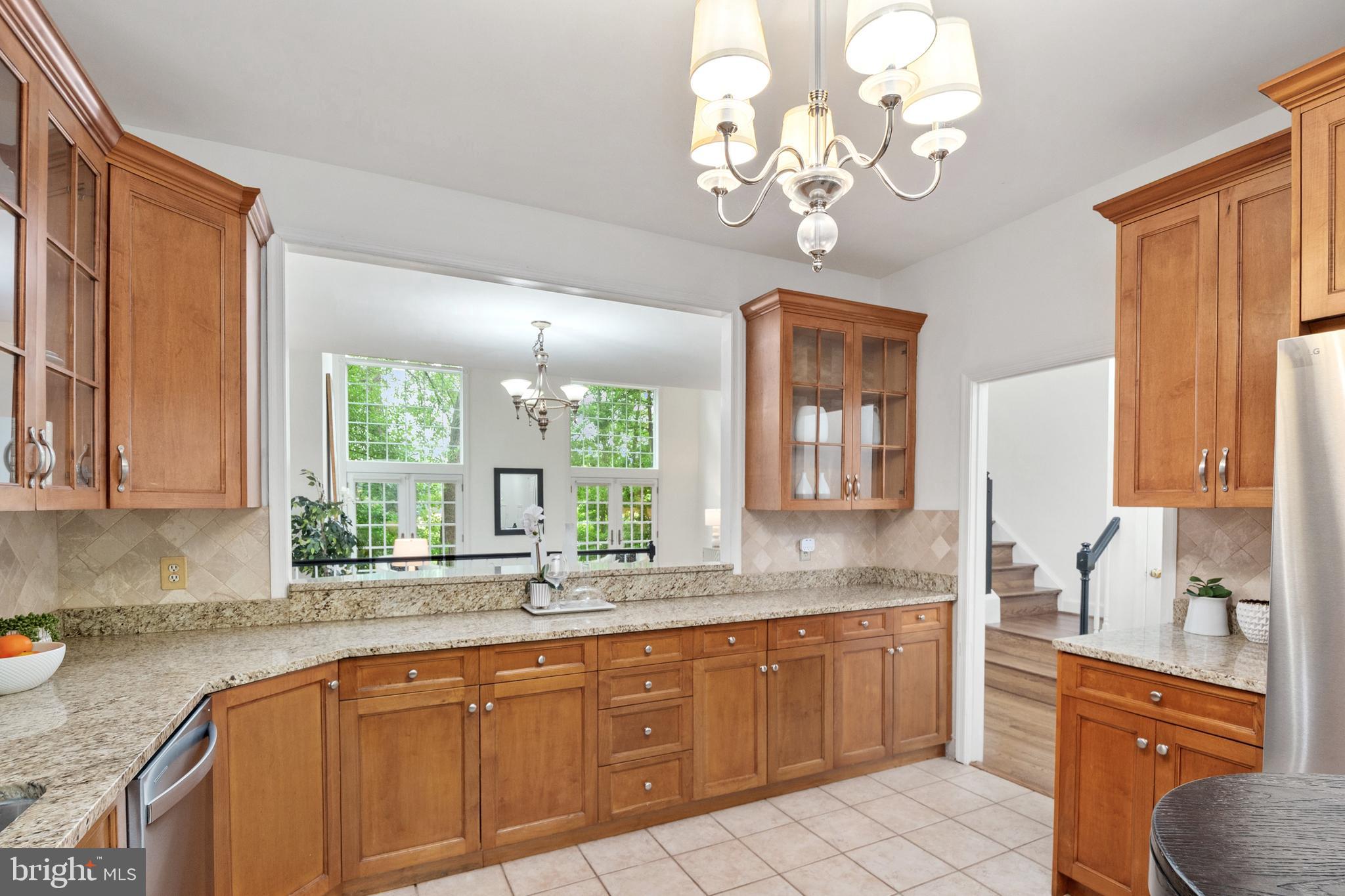 3729 Winfield Lane Northwest Washington, DC 20007 - Photo 10 of 22 a kitchen with stainless steel appliances granite countertop a sink dishwasher a stove with wooden cabinets and floor
