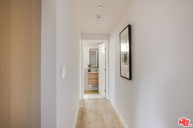 a view of a hallway with wooden floor