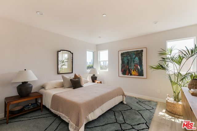 a bedroom with a large bed and a chandelier