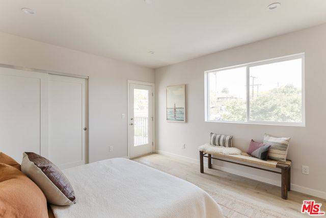 a bedroom with furniture and a window