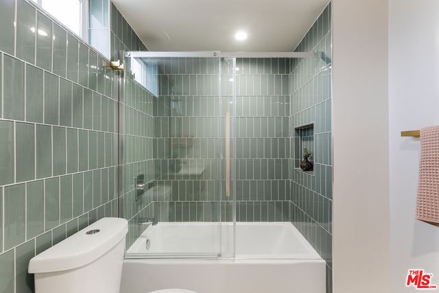 a bathroom with a bathtub and toilet
