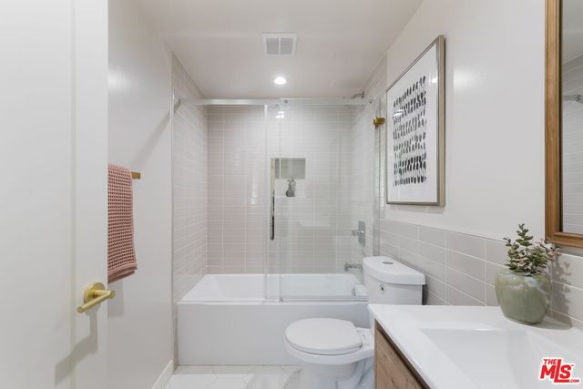 a bathroom with a toilet a sink and bathtub