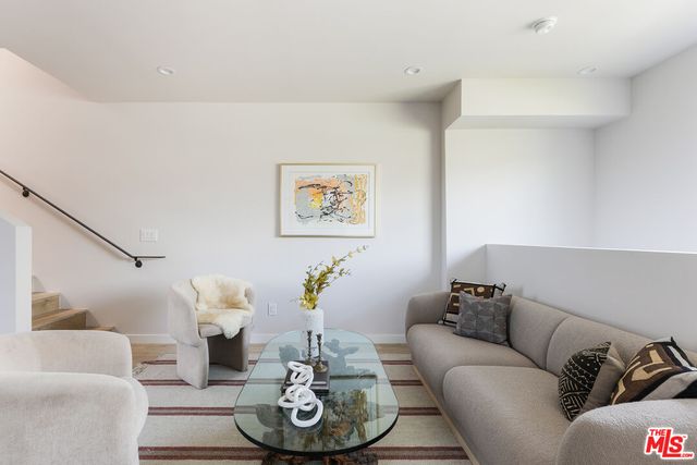 a living room with furniture and white couches